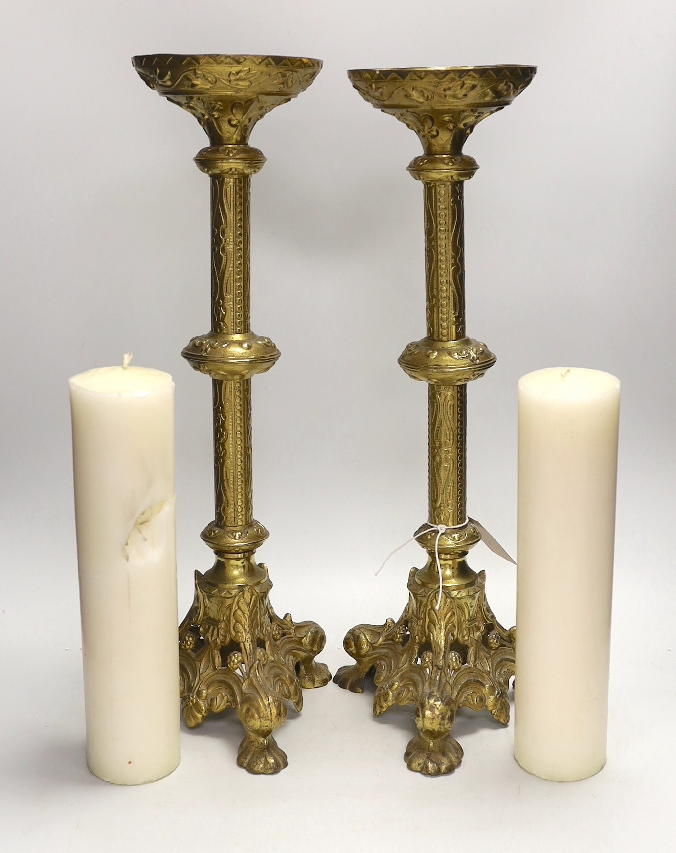 A pair of tall Victorian ecclesiastical brass candlestands, 51cms high